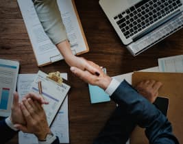 Business professionals reviewing shareholding documents Business professionals reviewing shareholding documents