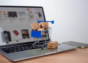 Person attaching shipping label to cardboard box in warehouse setting Person attaching shipping label to cardboard box in warehouse setting
