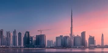 Panoramic night view of Dubai skyline featuring Burj Khalifa and surrounding skyscrapers Panoramic night view of Dubai skyline featuring Burj Khalifa and surrounding skyscrapers